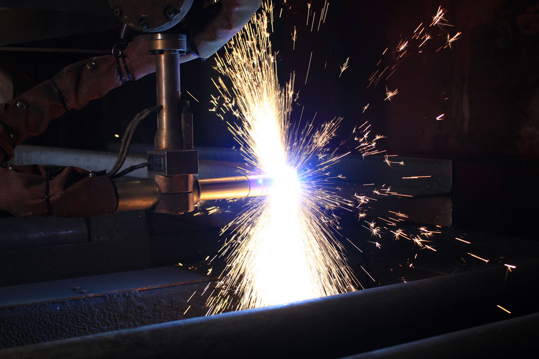 A plasma cutter cutting a component for large tooling or flight hardware for the aerospace, defense, and space industry